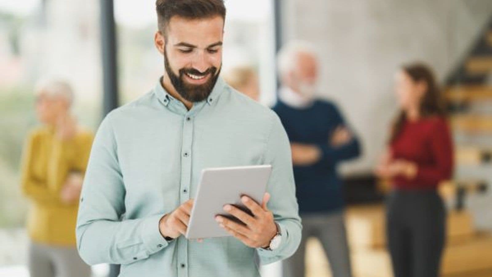 Field sales rep reviewing CRM notes on a tablet after a customer meeting