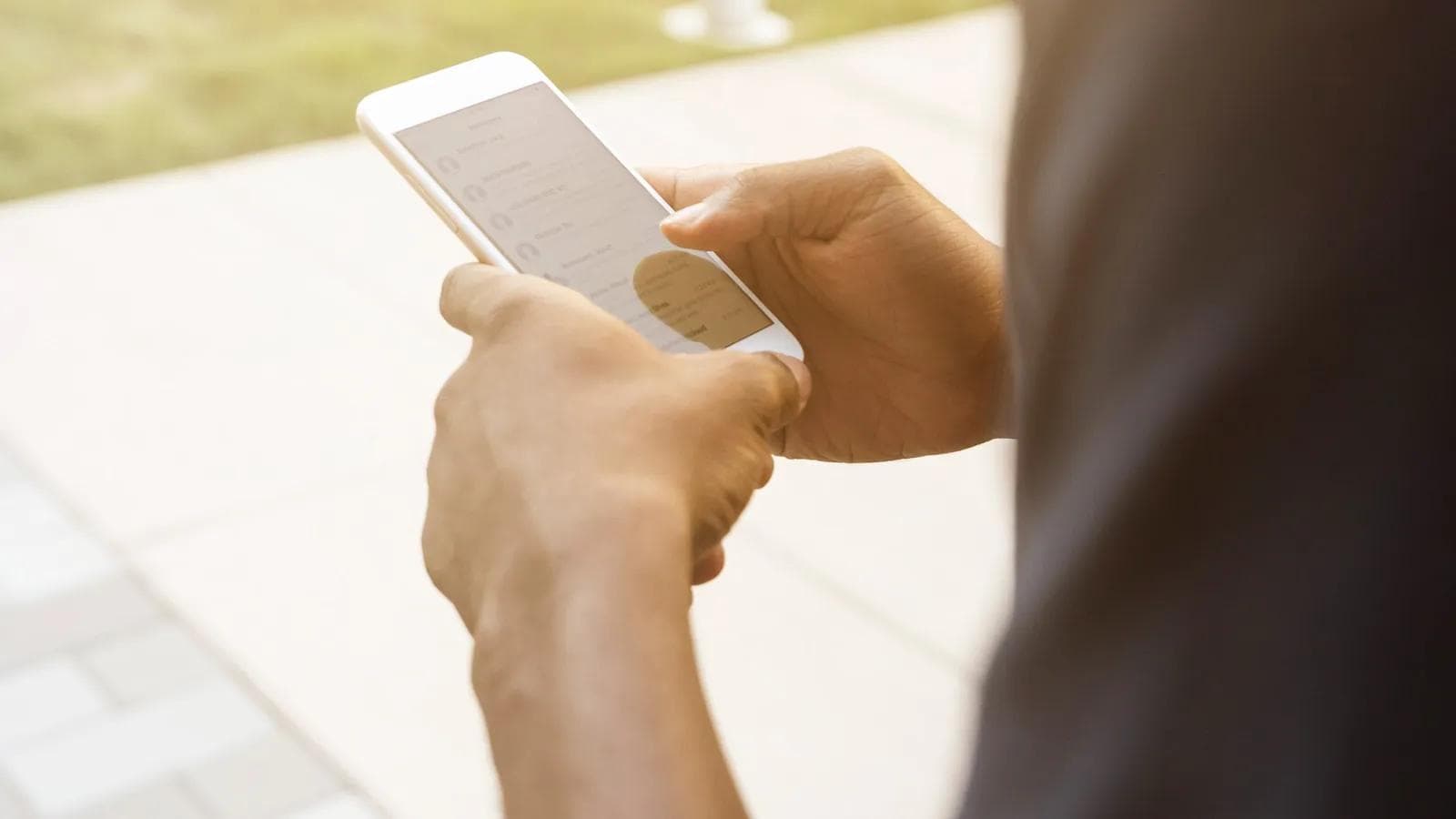 Field sales representative updating CRM from a smartphone between customer visits
